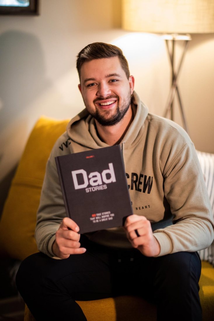 Colin Edwards holding the book Dad Stories